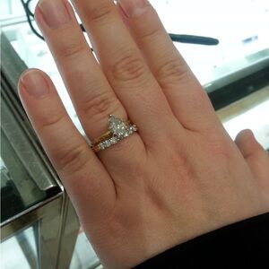 Pear solitaire engagement ring and diamond wedding band, solid yellow gold.